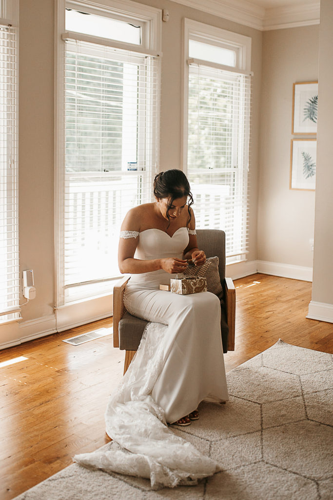 bride getting ready near window photo