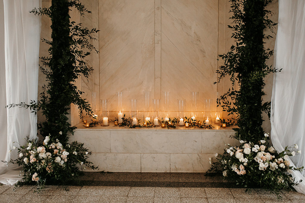 white and green elegant wedding florals setup at ceremony