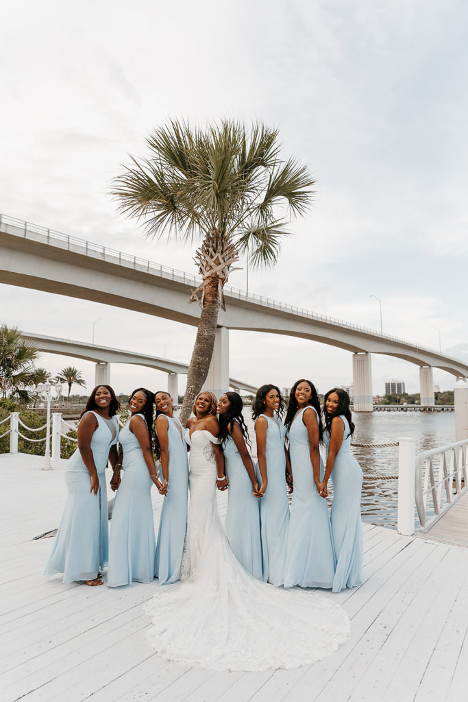 bridesmaids in blue dresses and elegant bride