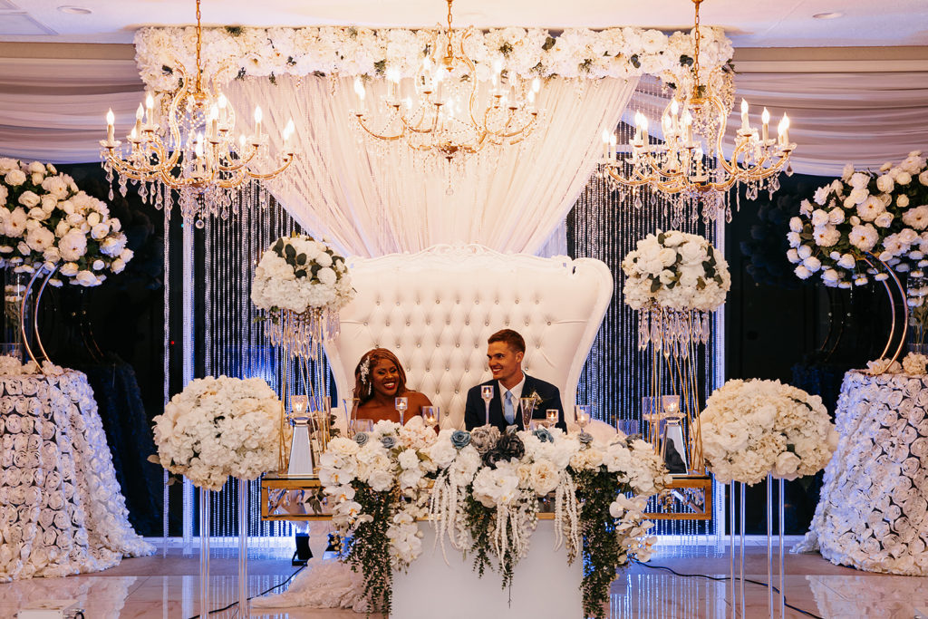 crystal ballroom wedding venue with white floral bouquets