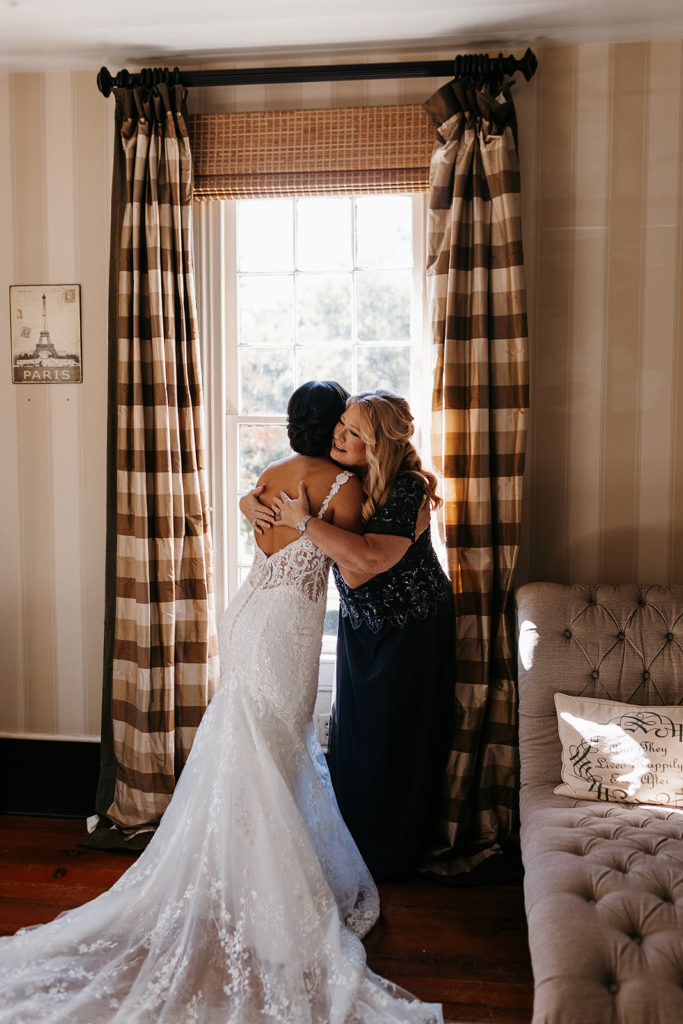 Bride hugging mother before wedding in GA