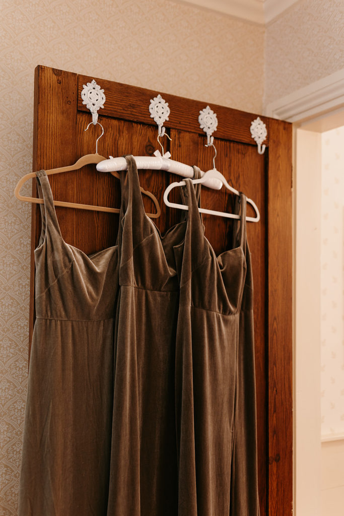 Bridesmaids dresses hanging off door
